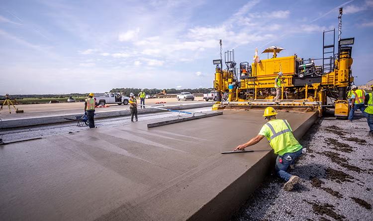 Airport runway paving crew finishing a concrete surface at a general aviation facility in Northern Virginia