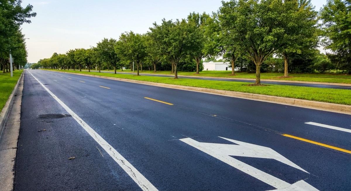 Asphalt maintenance program result — a commercial parking area kept in good condition with regular paving upkeep