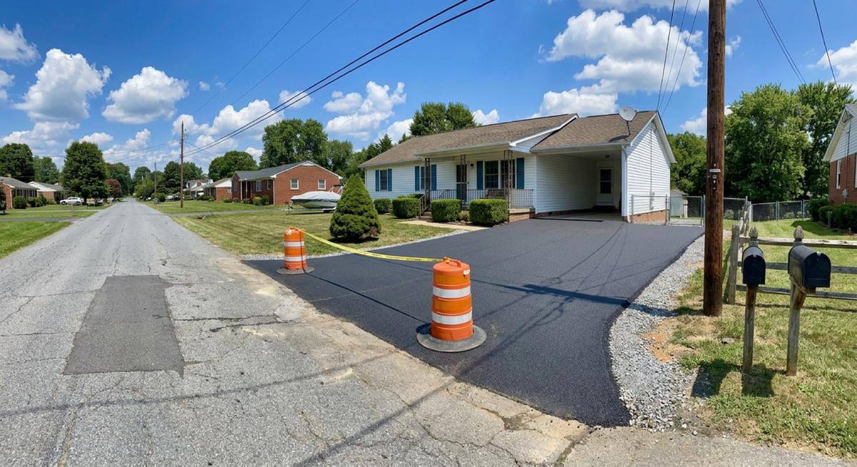Asphalt repaving completed on a residential driveway in McLean, VA, giving the surface a fresh, uniform finish