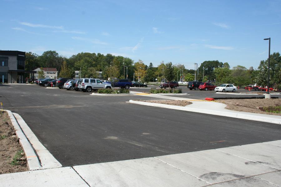 Can you put asphalt over concrete — a commercial parking area finished with an asphalt surface over concrete curbing and base