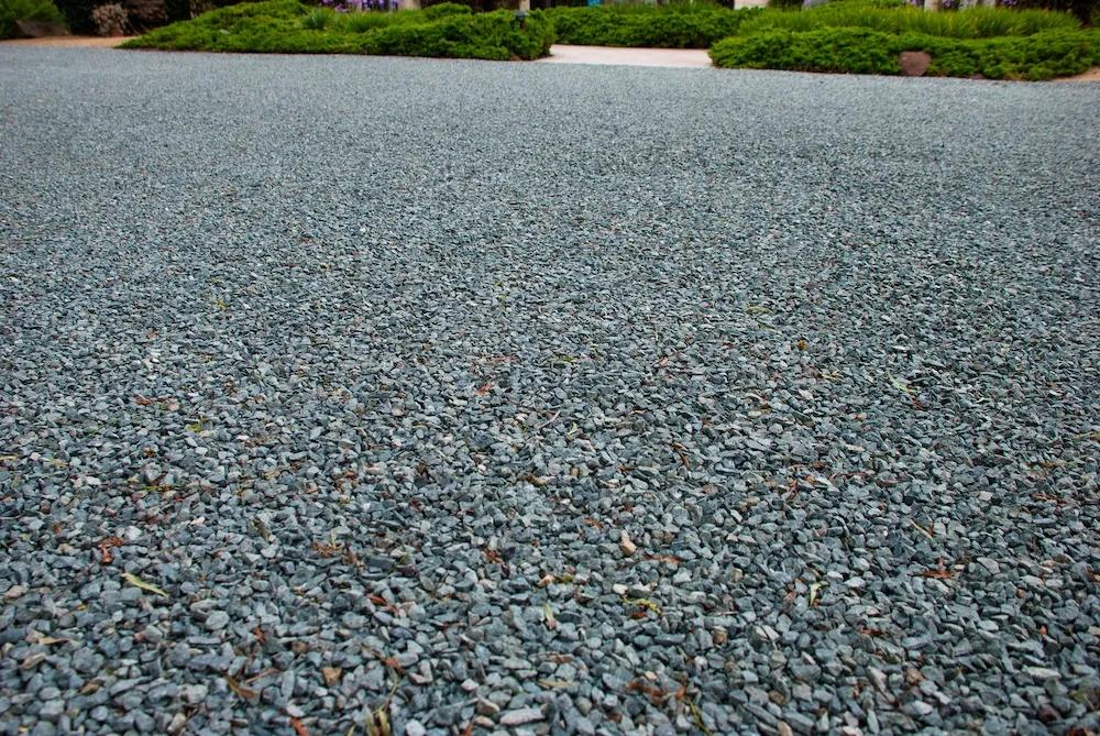 Chip and seal driveway finish in Northern Virginia, showing the textured gravel-and-oil surface up close
