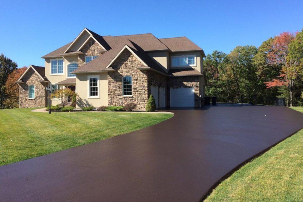 Colored asphalt sealer applied to a large estate driveway in Northern Virginia, giving it a rich brown tone