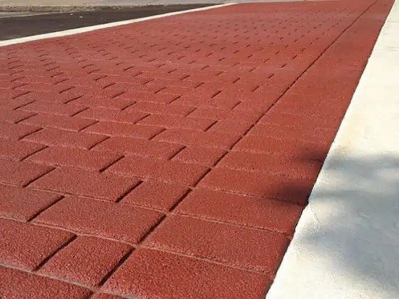 Stamped asphalt walkway finished in a red brick herringbone pattern in Northern Virginia